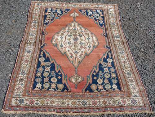 A Persian rug, late 19th/ early 20th century, the madder gro...