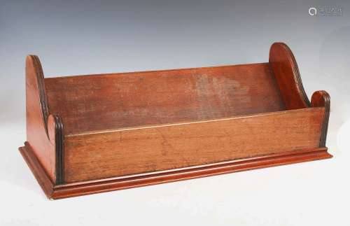 A 19th century mahogany book trough, the shaped ends with re...