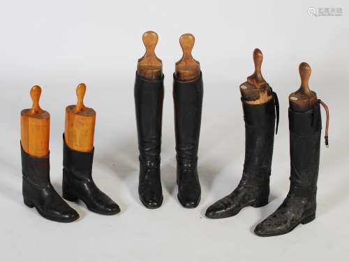 Three pairs of vintage black leather riding boots, each with...