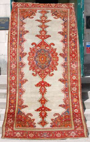 A Persian rug, late 19th/ early 20th century, the off-white ...