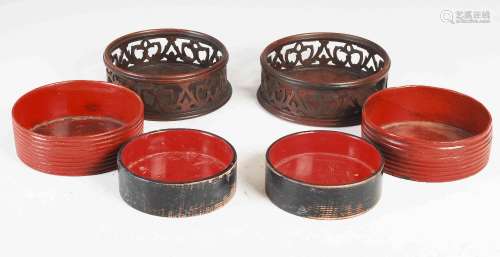 A pair of red lacquered Regency papier-mache bottle coasters...