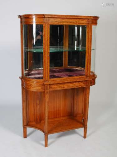 A late 19th century satinwood and ebony lined display cabine...
