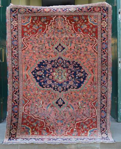 A Persian rug, late 19th/ early 20th century, the salmon pin...