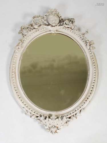 A late 19th century later painted giltwood oval wall mirror,...