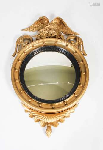 A 19th century giltwood Regency style convex wall mirror, wi...