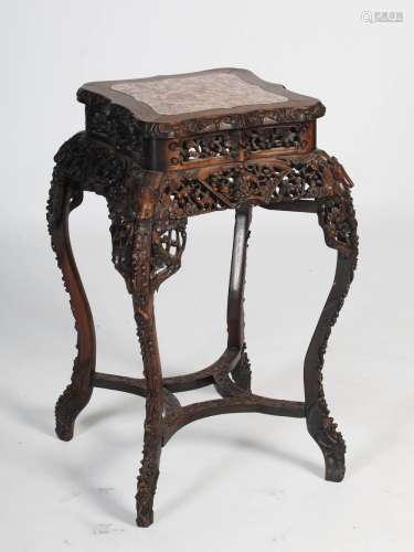 A Chinese dark wood urn stand, Qing Dynasty, the shaped squa...