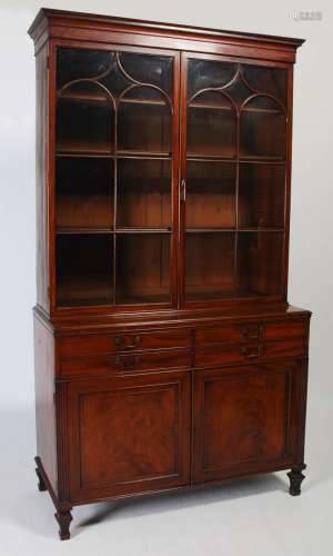 A George III mahogany bookcase, the moulded cornice above a ...