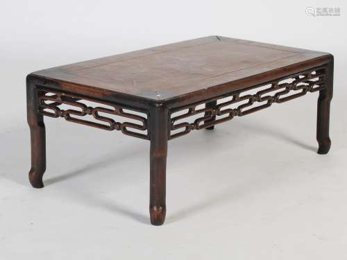A Chinese dark wood Kang table, Qing Dynasty, the panelled r...