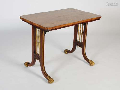A 19th century rosewood and parcel gilt reading table, the r...