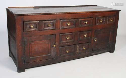 A late 18th/ early 19th century oak dresser, the planked rec...