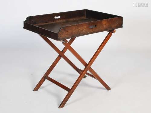 A 19th century laburnum butler's tray on later mahogany stan...