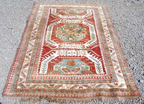 A Persian rug, early 20th century, the russet madder coloure...