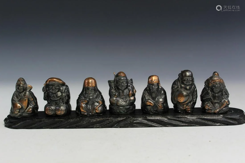 Seven Japanese Figurines on Wood Stand