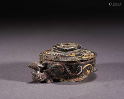 A bronze box ware with gold and silver