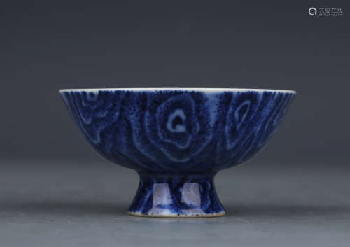 A blue and white stem cup
