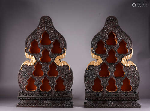 A pair of red sandalwood gourd-shaped antique-and-curio shel...