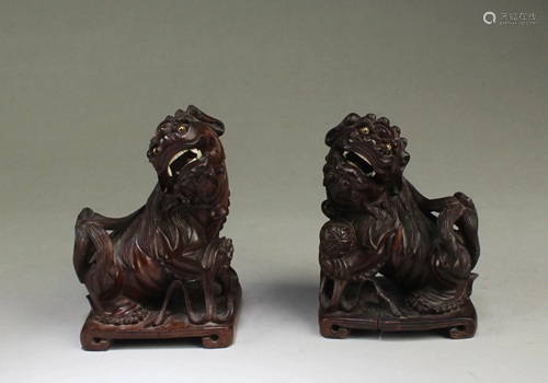 A Pair of Carved Wooden Mythical Beast Figurines