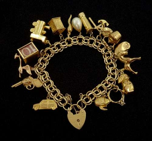 Gold link bracelet with heart locket and fifteen 9ct gold ch...