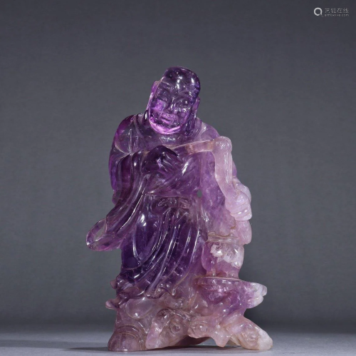 AN AMETHYST CARVED FIGURINE OF AN ARHAT