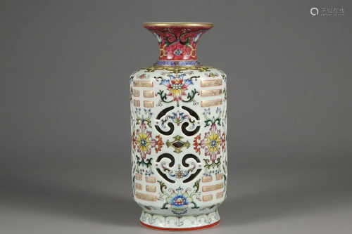 AN ENAMELED OPENWORK FLORAL REVOLVING VASE