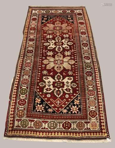 A KARABAGH RUG, the blood red field with four cruciform meda...