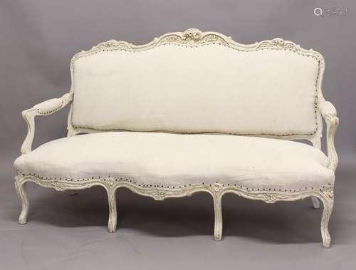 A LOUIS XV STYLE PAINTED CANAPE, the wavy top rail carved wi...