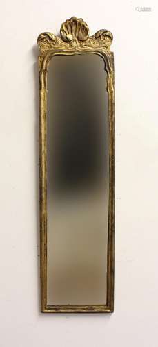 A GEORGE I/II GILTWOOD MIRROR. A narrow rectangular wall mir...