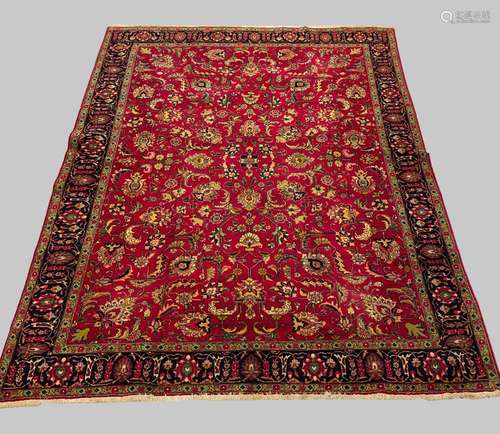 A TABRIZ CARPET, North West Iran, c.1950, the raspberry fiel...