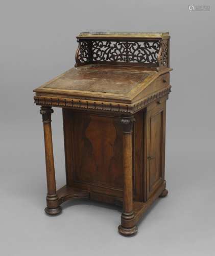 A VICTORIAN ROSEWOOD DAVENPORT, the brass-galleried top abov...