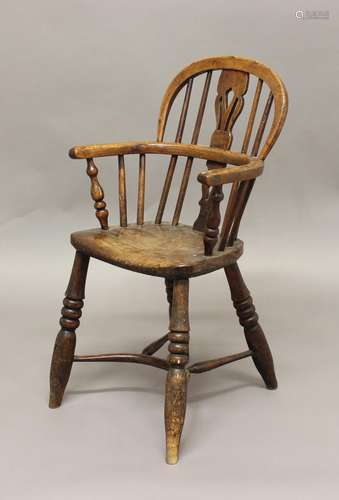 A VICTORIAN CHILD'S BEECH AND ELM WINDSOR ARMCHAIR, with a h...