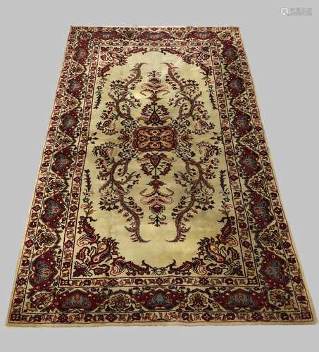 AN ORIENTAL CARPET, mid 20th century, the ivory field of flo...