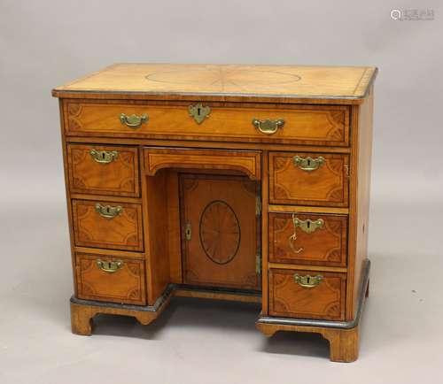 A GEORGE III SATINWOOD VENEERED KNEEHOLE DESK. The desk elab...