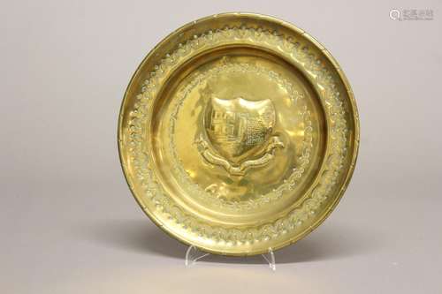 A 19TH CENTURY BRASS ALMS DISH. A brass alms dish, the centr...