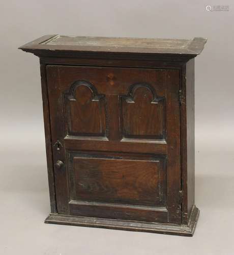 AN 18TH CENTURY OAK SPICE CUPBOARD, The door with two arched...