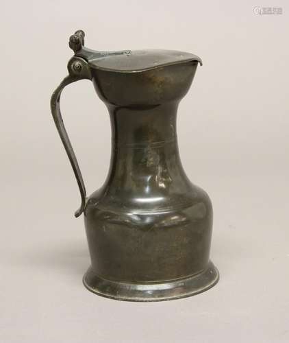 A 19TH CENTURY CONTINENTAL PEWTER FLAGON. A pewter flagon wi...