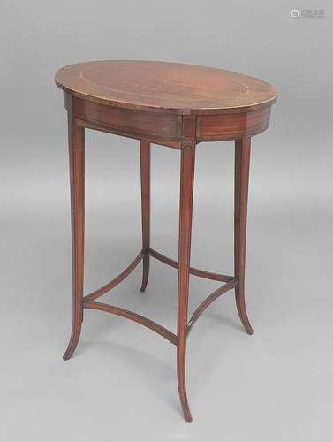 A SHERATON STYLE SATINWOOD WORK TABLE, the oval top on slend...