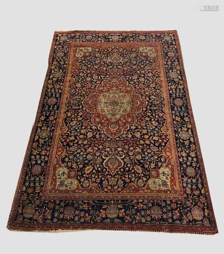 A KURK KASHAN RUG, Central Iran, c.1920, the deep indigo fie...