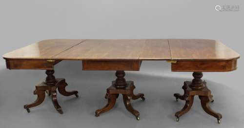 A GEORGE IV MAHOGANY TRIPLE PILLAR DINING TABLE. The table c...