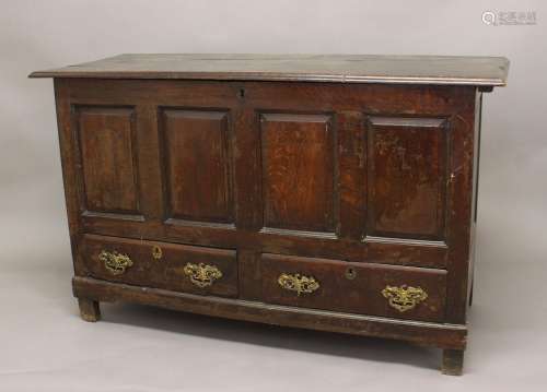 AN 18TH CENTURY OAK DOWRY CHEST, the panelled front above tw...