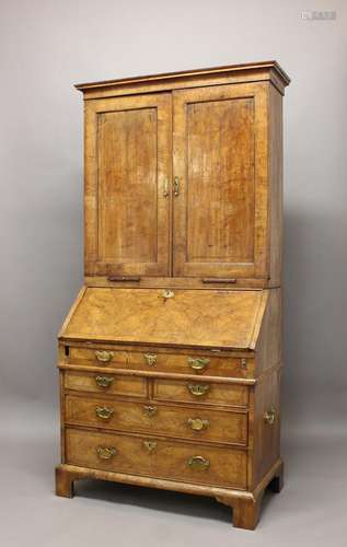 A GEORGE I WALNUT BUREAU CABINET. The upper section with a m...