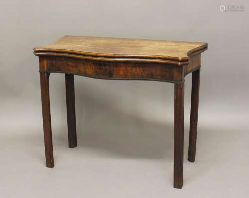 A GEORGE III MAHOGANY TEA TABLE. The serpentine fronted top ...