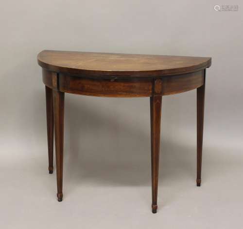 A GEORGE III MAHOGANY 'D' SHAPED CARD TABLE. The fold top wi...