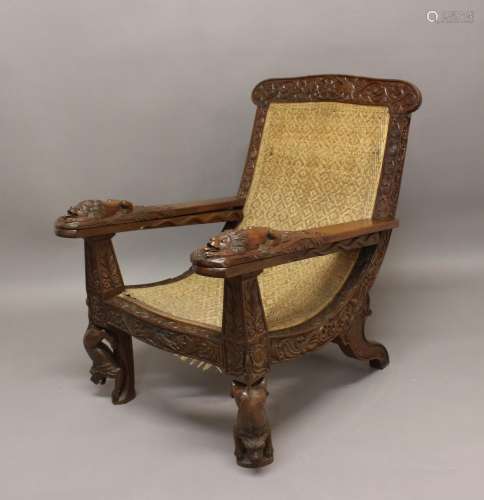 A LATE 19TH/EARLY 20TH CENTURY TEAK PLANTERS CHAIR. A teak p...