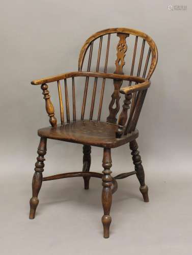 AN ASH AND ELM WINDSOR CHAIR, the arched spindle back with w...