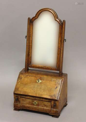 A QUEEN ANNE WALNUT TOILET MIRROR, the shaped mirror above a...