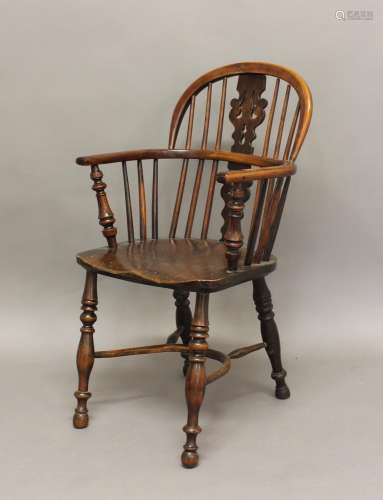 A YEW AND ELM WINDSOR CHAIR, the arched back with pierced sp...