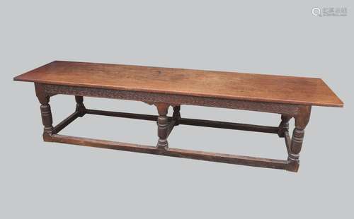 AN OAK AND WALNUT REFECTORY TYPE DINING TABLE. With a broad ...