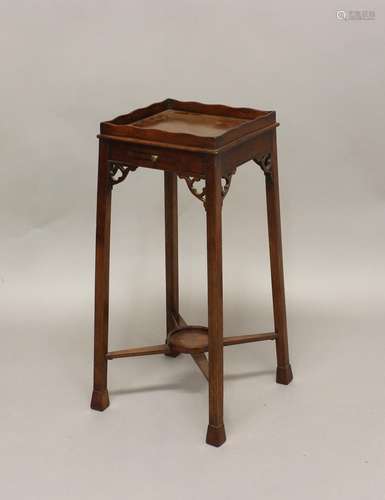 A GEORGE III MAHOGANY URN STAND, the wavy gallery above a sl...