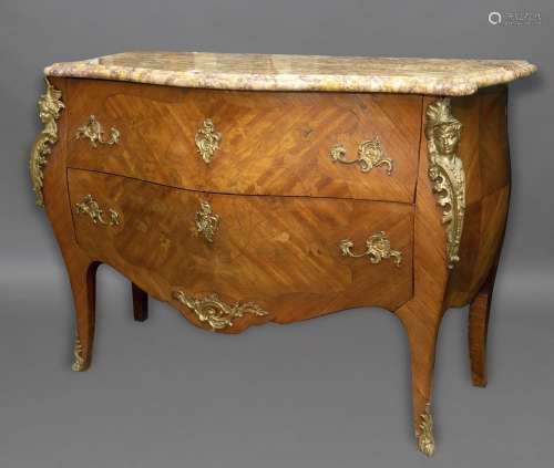A LOUIS XVI STYLE MARBLE TOPPED COMMODE. The variegated marb...