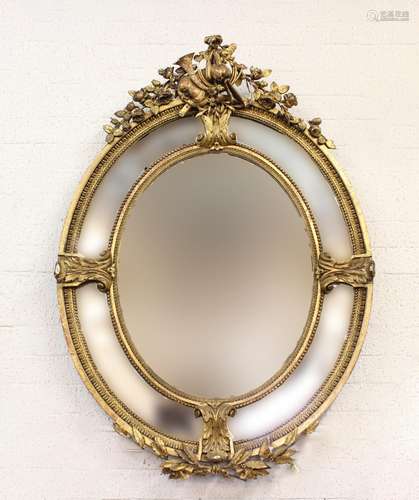 A GEORGE III STYLE CARVED GESSO WALL MIRROR. A gilt framed w...